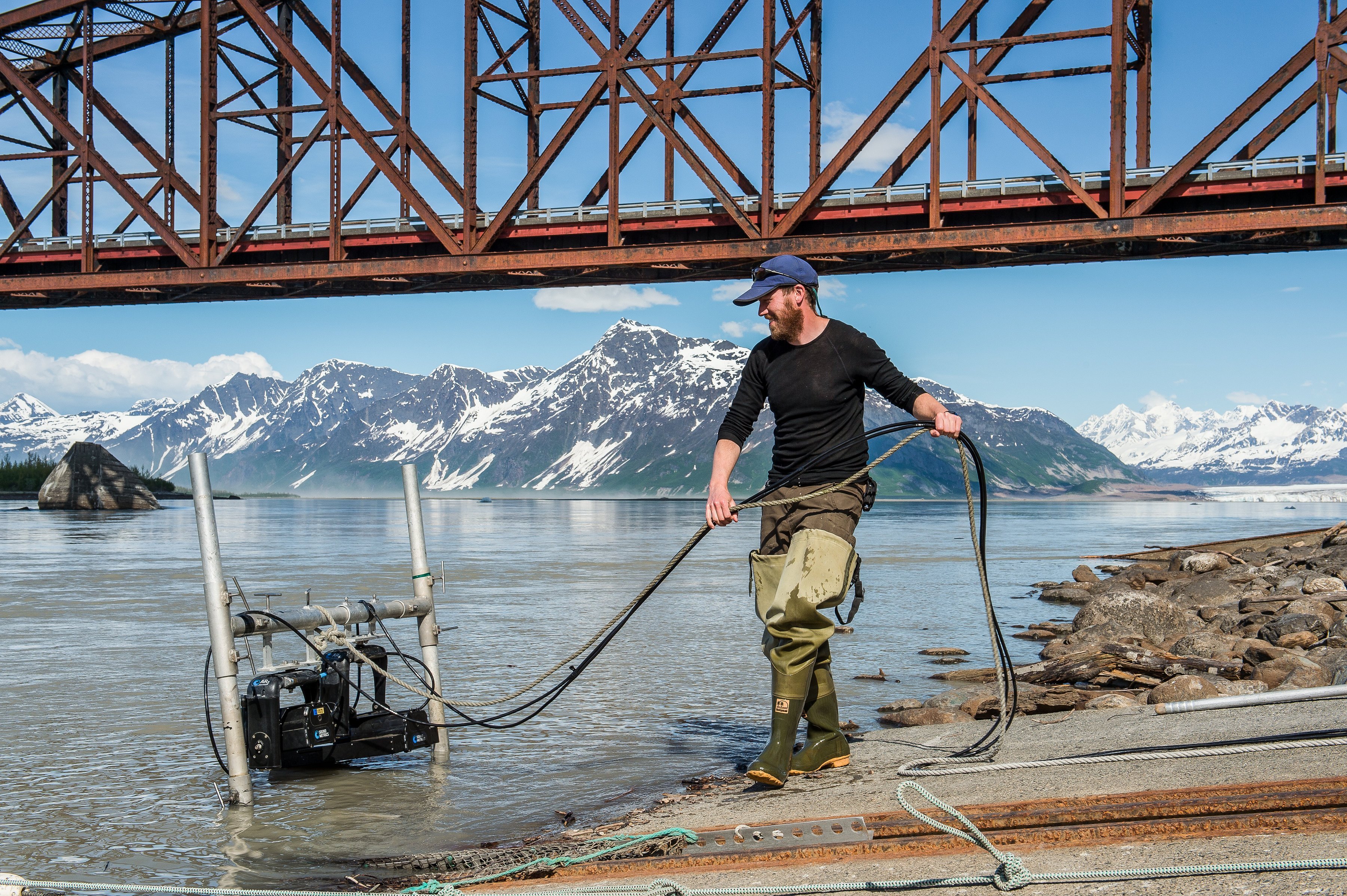 Fisheries biologist Shane Shepard deploys sonar technology in Copper River near the Million Dollar Bridge northeast of Cordova.