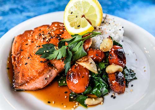 Salmon Recipes - Salmon Filet on Cutting Board with Fruit and Herbs