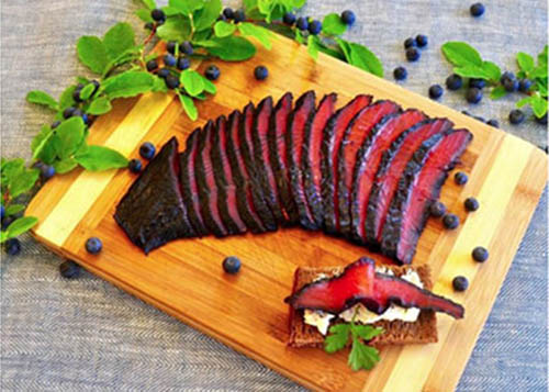 Slices of Blueberry Salmon Gravlax on Cutting Board