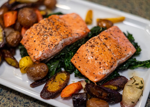 Salmon Steak Over Bed of Mixed Greens